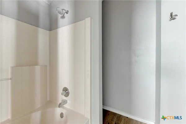 a bathroom with a shower and a bathtub