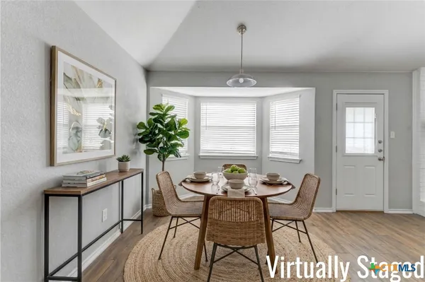 a view of a dining room with furniture and window