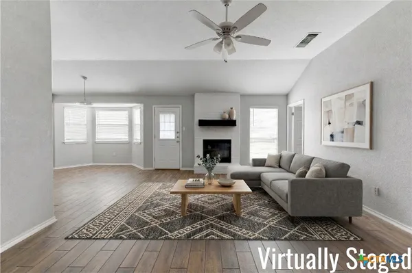 a living room with furniture and a fireplace