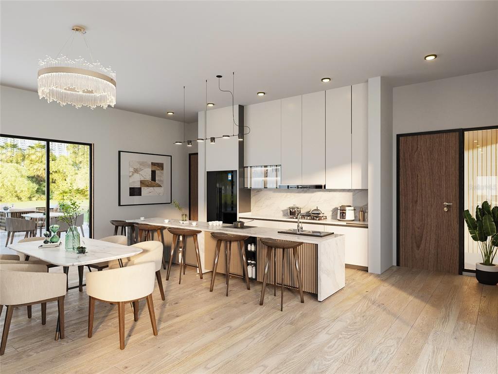 Alpinia Rd Port North Port, FL 34288 - Photo 3 of 4 a kitchen with stainless steel appliances granite countertop a stove a refrigerator a kitchen island a dining table and chairs with wooden floor