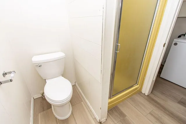 a white toilet sitting next to a sink