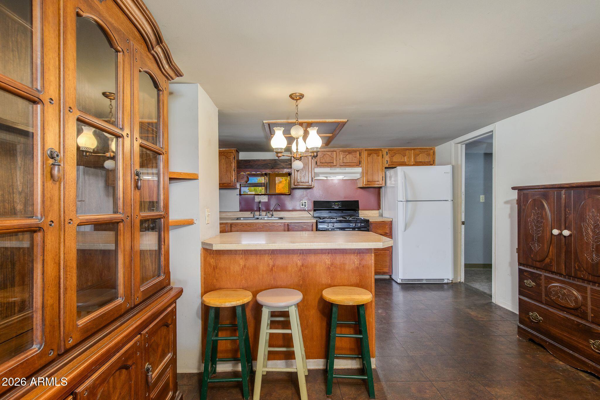 316 West Roeser Road Phoenix, AZ 85041 - Photo 8 of 35 a kitchen with stainless steel appliances granite countertop a refrigerator and microwave