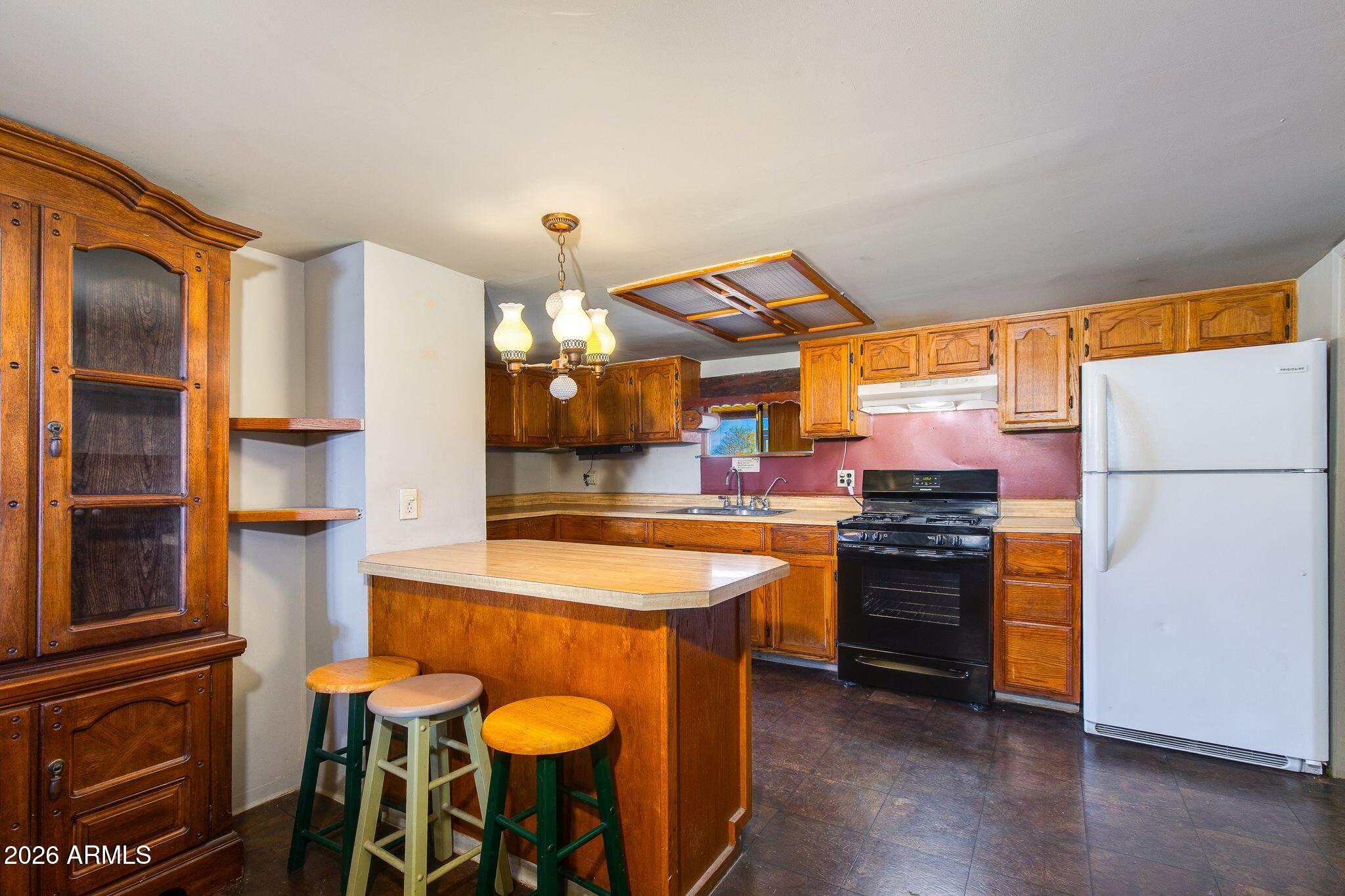 316 West Roeser Road Phoenix, AZ 85041 - Photo 9 of 35 a kitchen with stainless steel appliances granite countertop a stove and a refrigerator