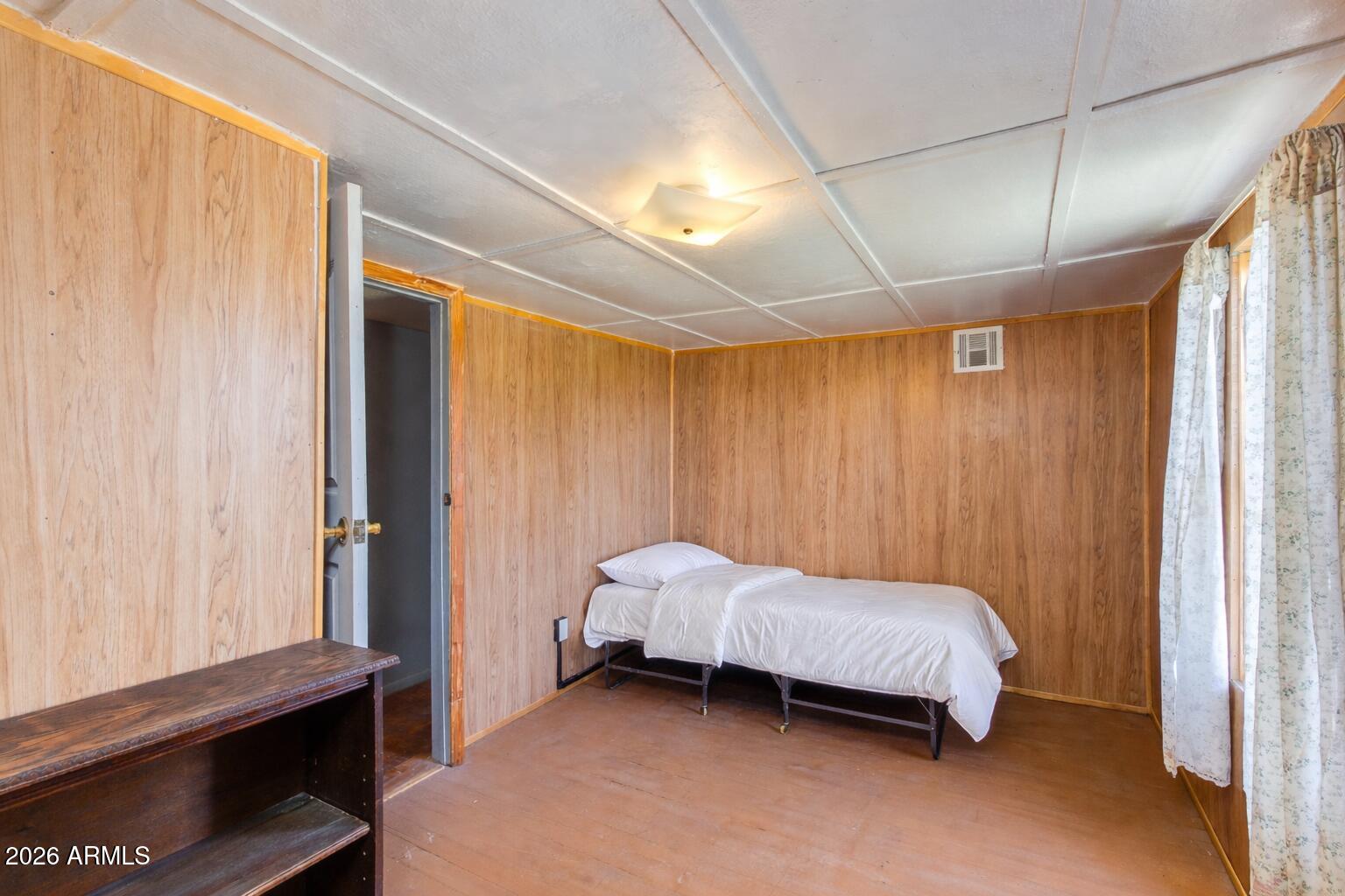 316 West Roeser Road Phoenix, AZ 85041 - Photo 12 of 35 a bedroom with a bed and a window