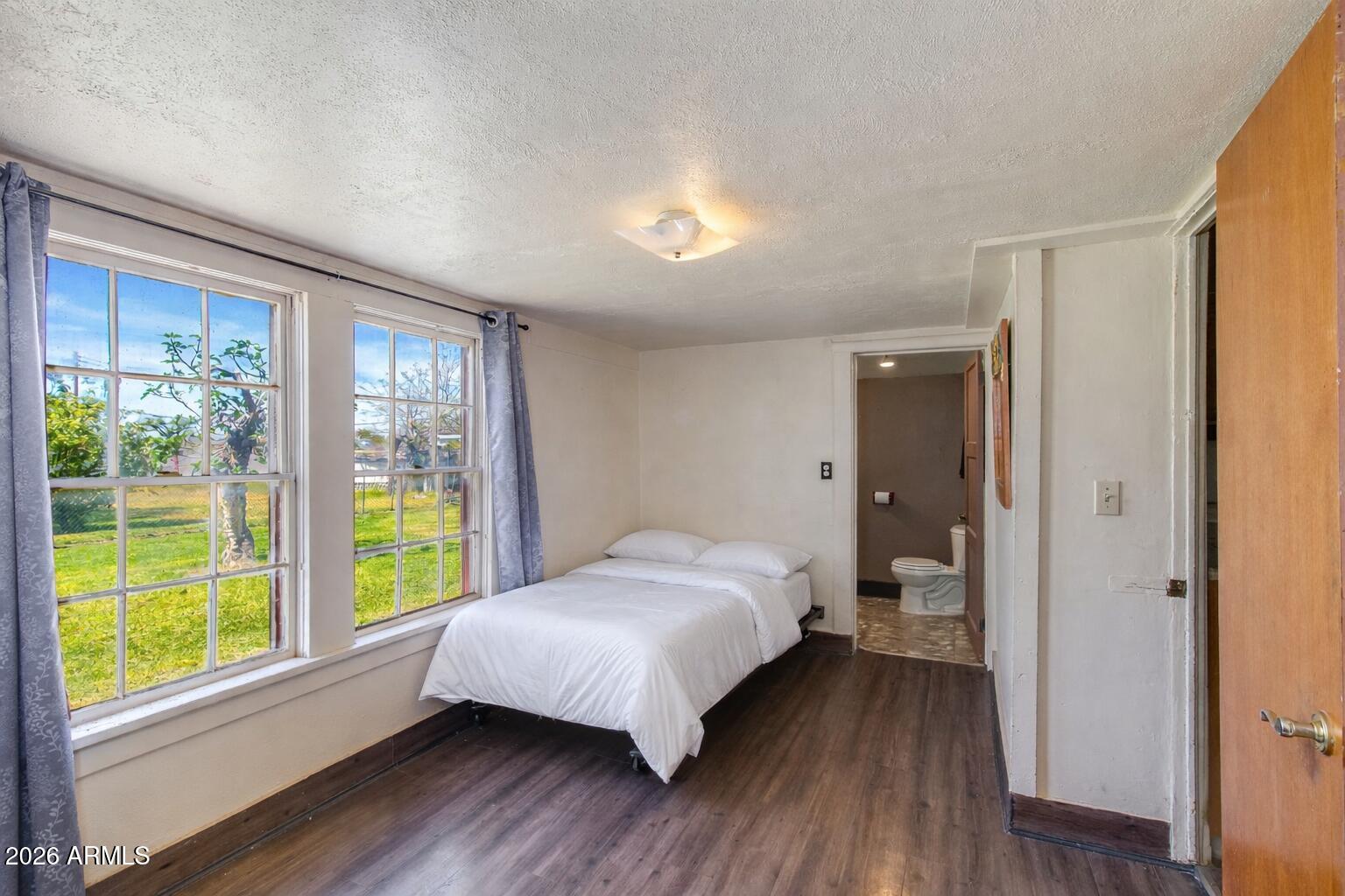 316 West Roeser Road Phoenix, AZ 85041 - Photo 13 of 35 a bedroom with a bed and a large window