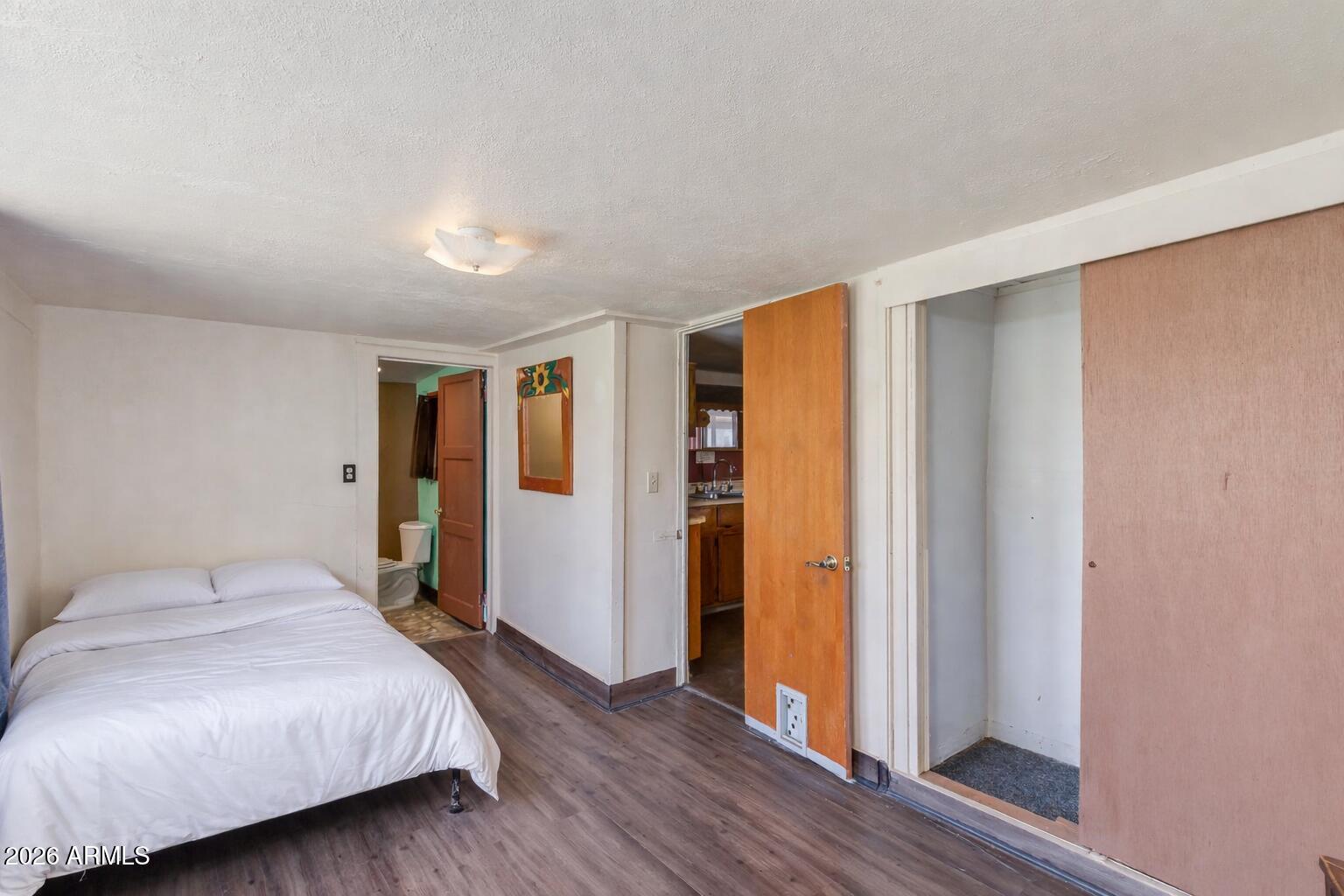 316 West Roeser Road Phoenix, AZ 85041 - Photo 14 of 35 a bedroom with a bed and wooden floor