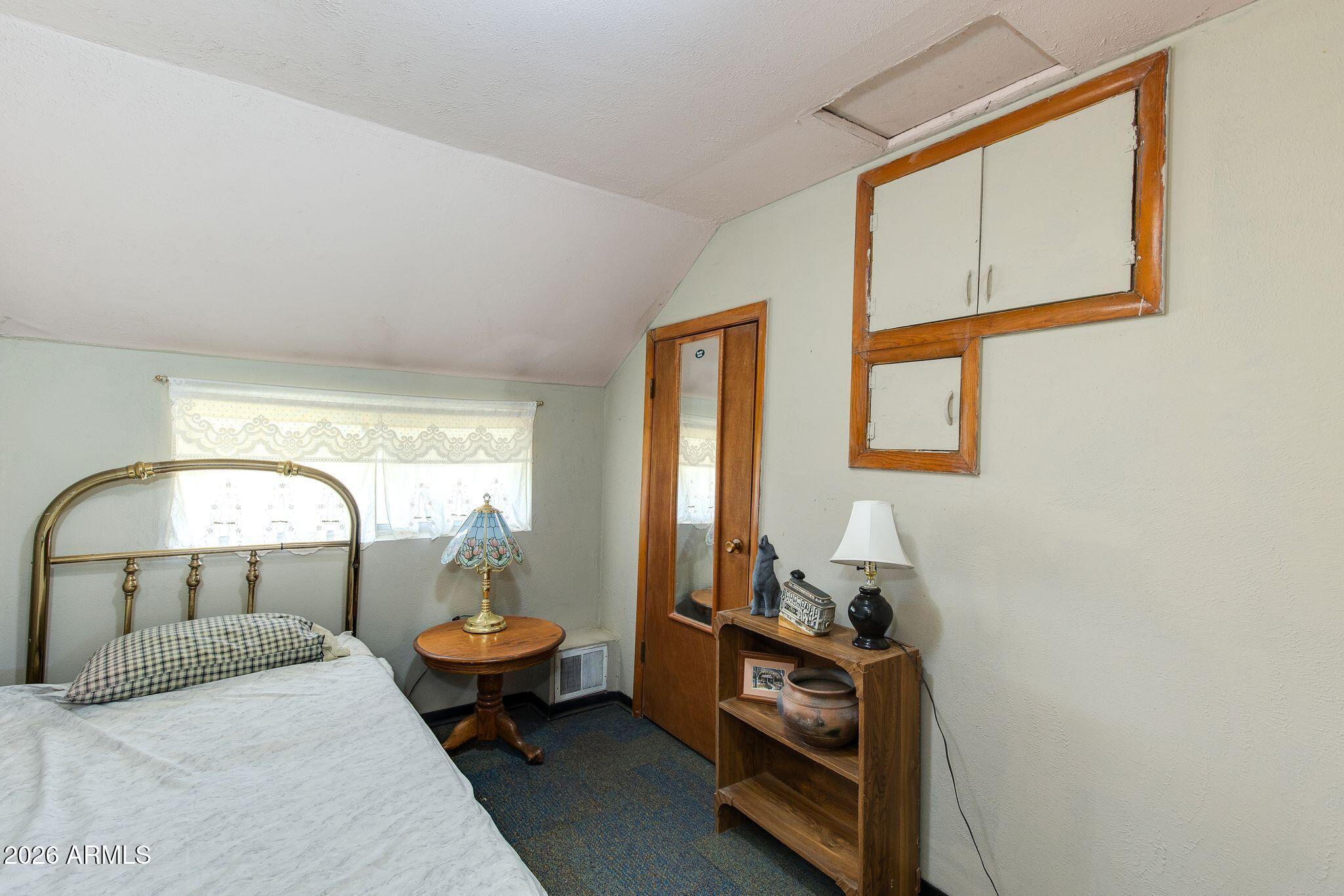 316 West Roeser Road Phoenix, AZ 85041 - Photo 23 of 35 a bedroom with a bed and a mirror