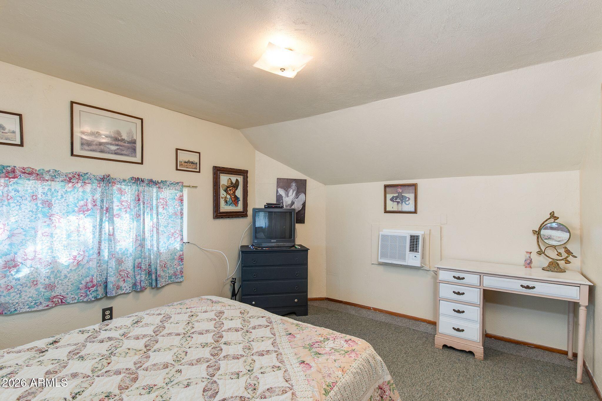 316 West Roeser Road Phoenix, AZ 85041 - Photo 24 of 35 a bedroom with a bed and a window