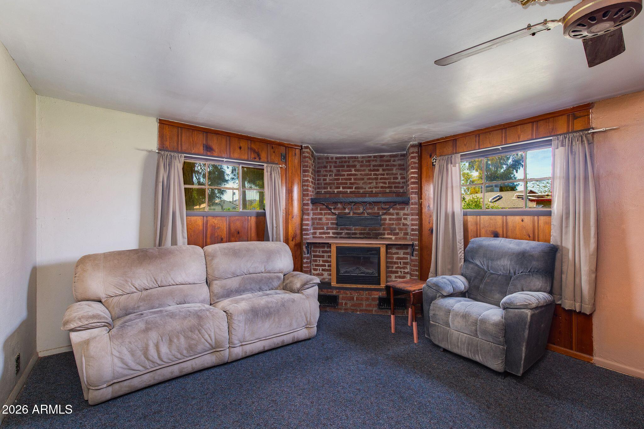 316 West Roeser Road Phoenix, AZ 85041 - Photo 5 of 35 a living room with furniture and a fireplace