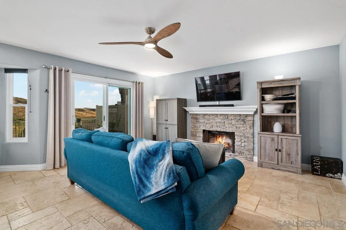 10145 Greenleaf Road Spring Valley, CA 91977 - Photo 12 of 37 a living room with furniture a flat screen tv and a fireplace