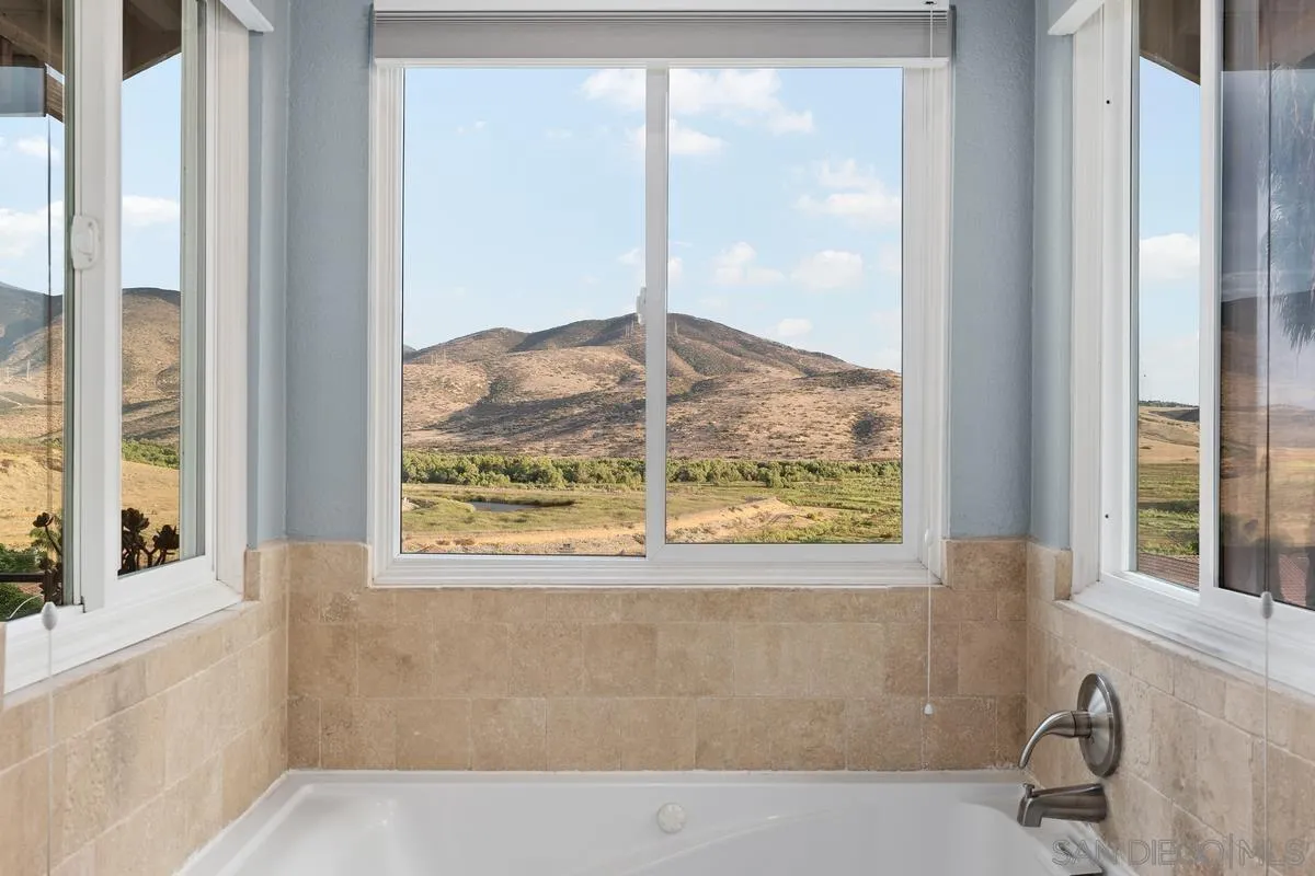 10145 Greenleaf Road Spring Valley, CA 91977 - Photo 17 of 37 a view of a bathtub in a room next to a window