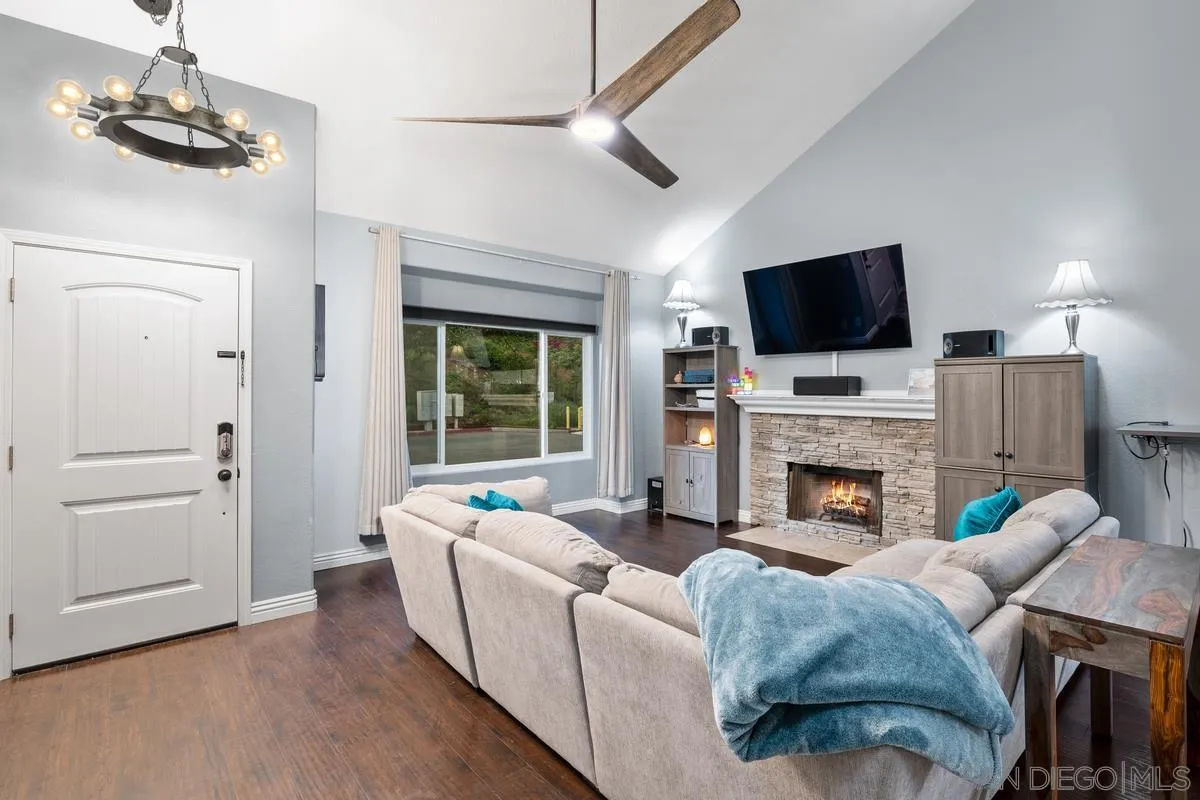 10145 Greenleaf Road Spring Valley, CA 91977 - Photo 21 of 37 a living room with furniture a fireplace and a flat screen tv