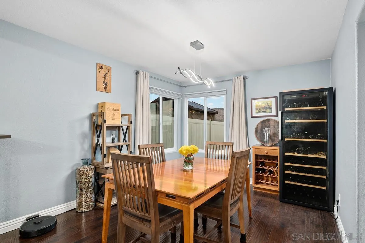 10145 Greenleaf Road Spring Valley, CA 91977 - Photo 25 of 37 a view of a dining room with furniture and wooden floor