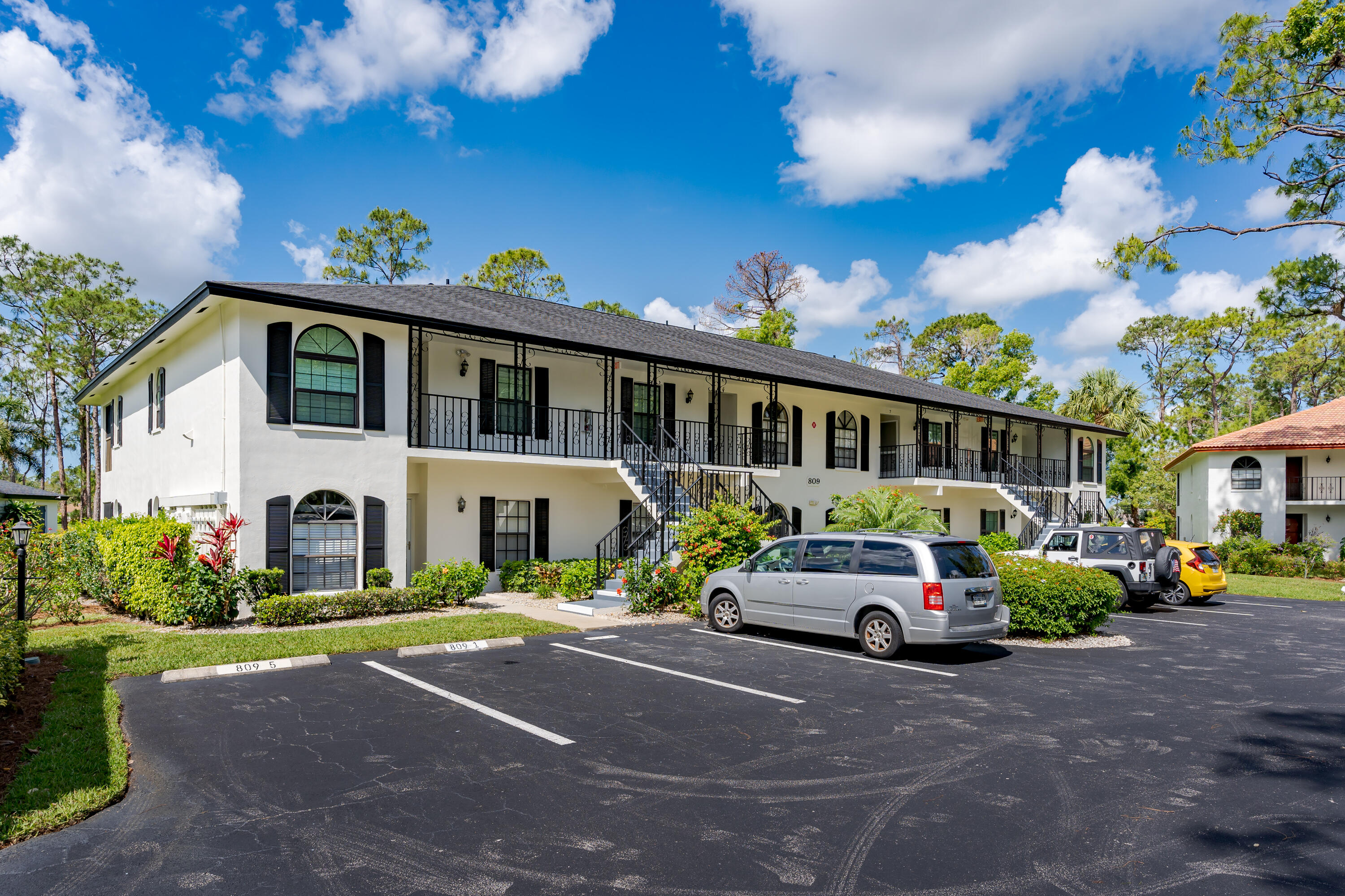 809 Augusta Boulevard, Unit 6 Naples, FL 34113 - Photo 1 of 24 a car parked in front of a house