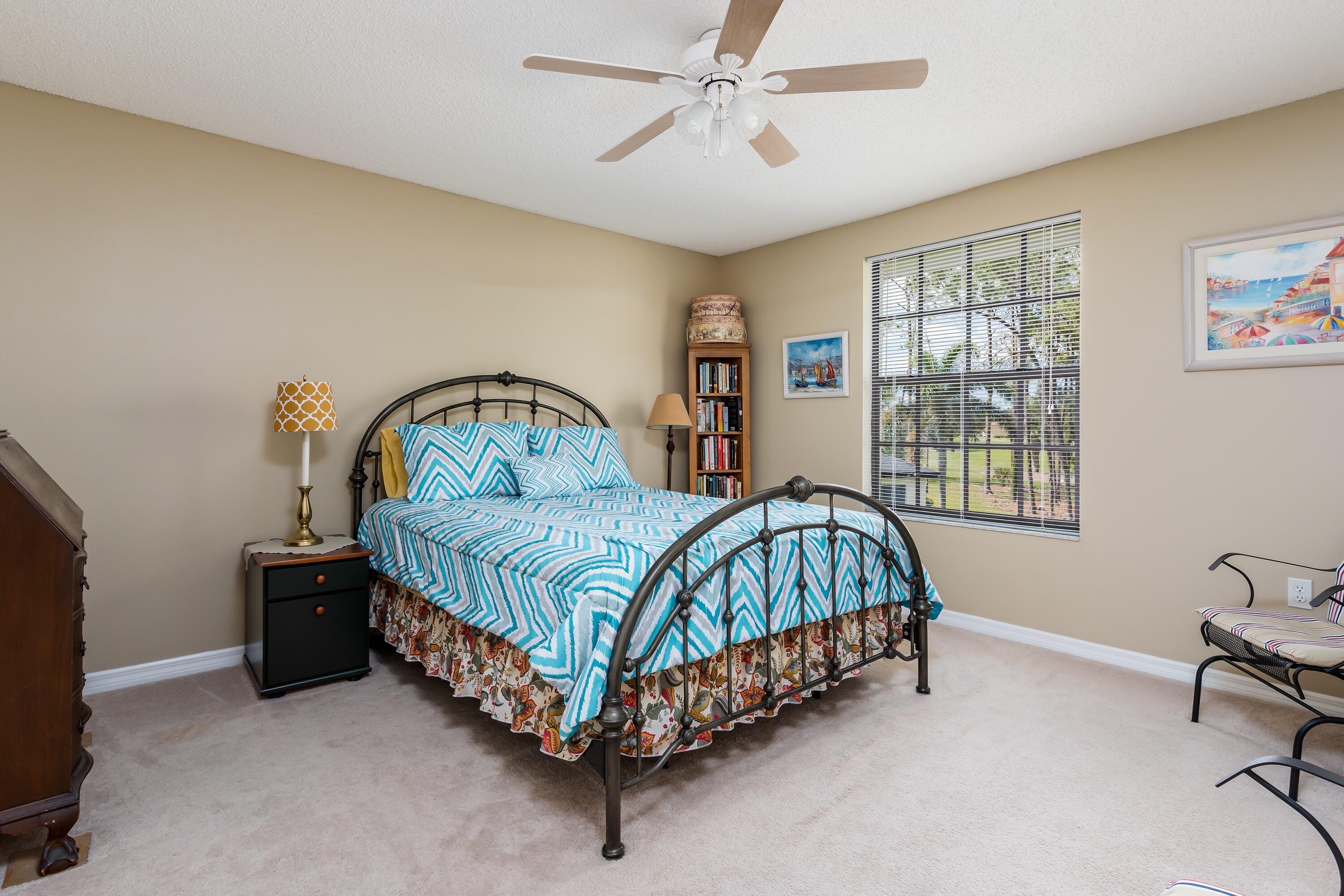 809 Augusta Boulevard, Unit 6 Naples, FL 34113 - Photo 11 of 24 a bedroom with a bed table chair and a window