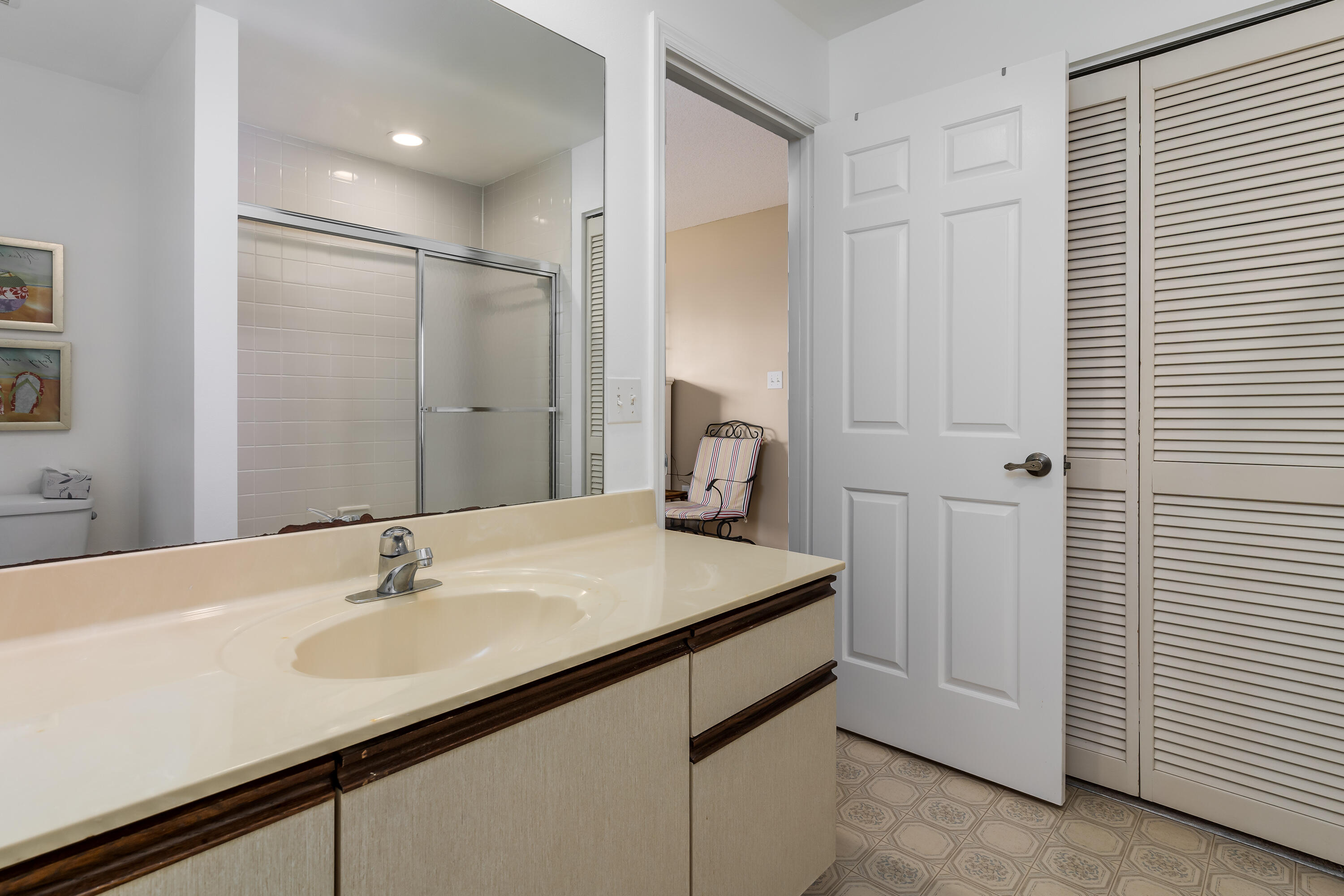 809 Augusta Boulevard, Unit 6 Naples, FL 34113 - Photo 12 of 24 a bathroom with a sink and a mirror