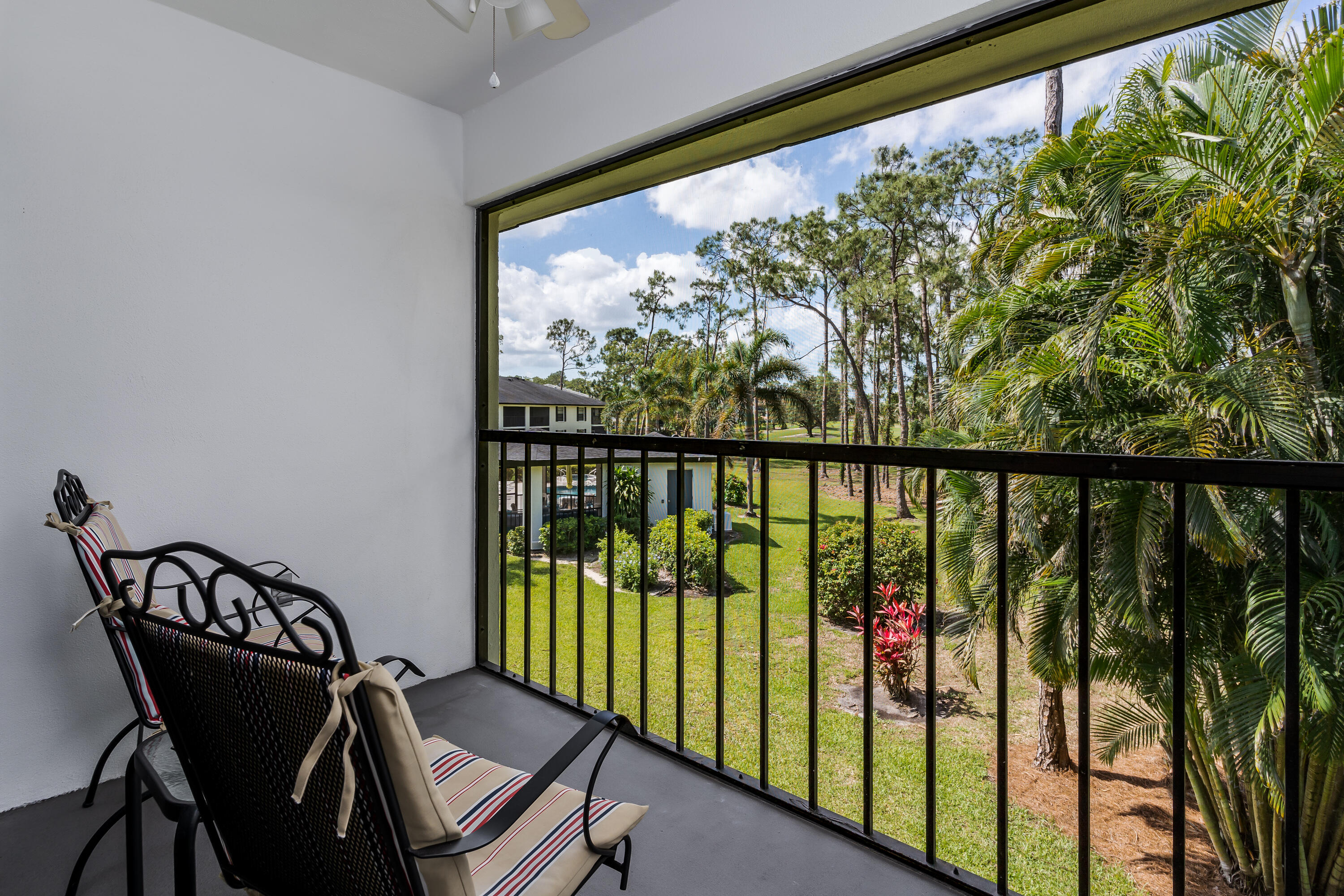 809 Augusta Boulevard, Unit 6 Naples, FL 34113 - Photo 17 of 24 a view of a chairs and table in balcony