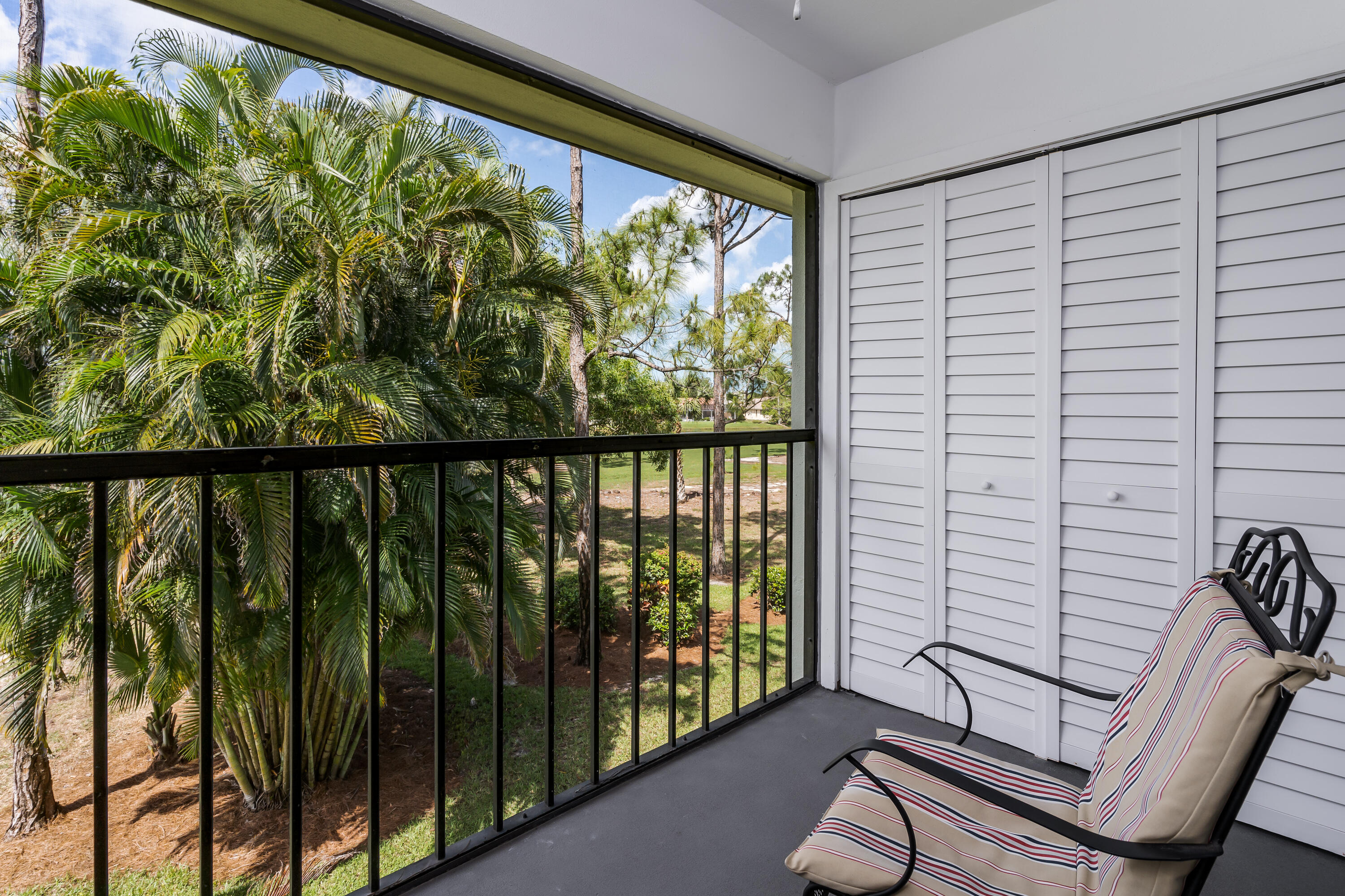 809 Augusta Boulevard, Unit 6 Naples, FL 34113 - Photo 18 of 24 a view of a porch with a bench