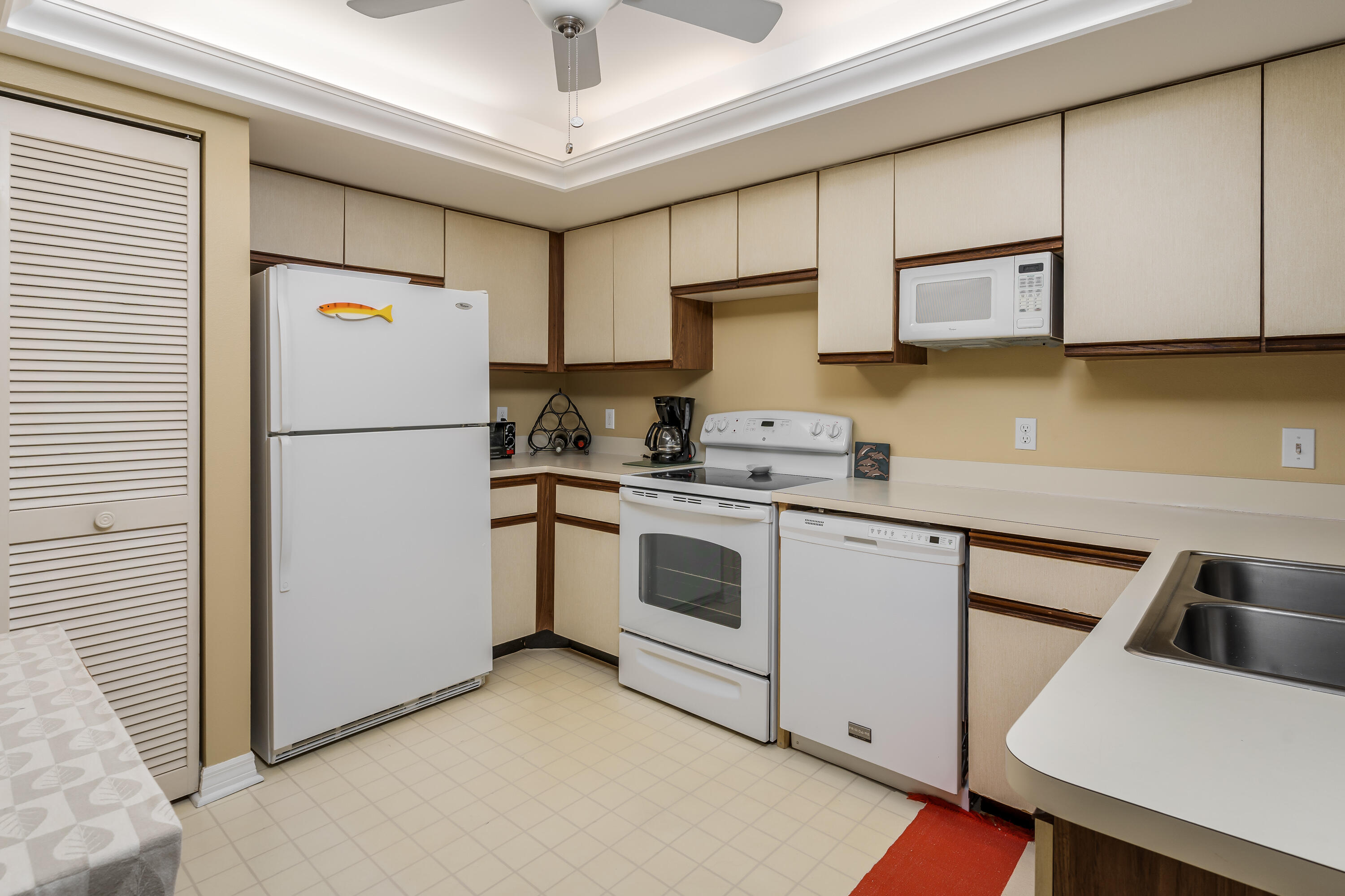 809 Augusta Boulevard, Unit 6 Naples, FL 34113 - Photo 2 of 24 a white refrigerator freezer sitting in a kitchen