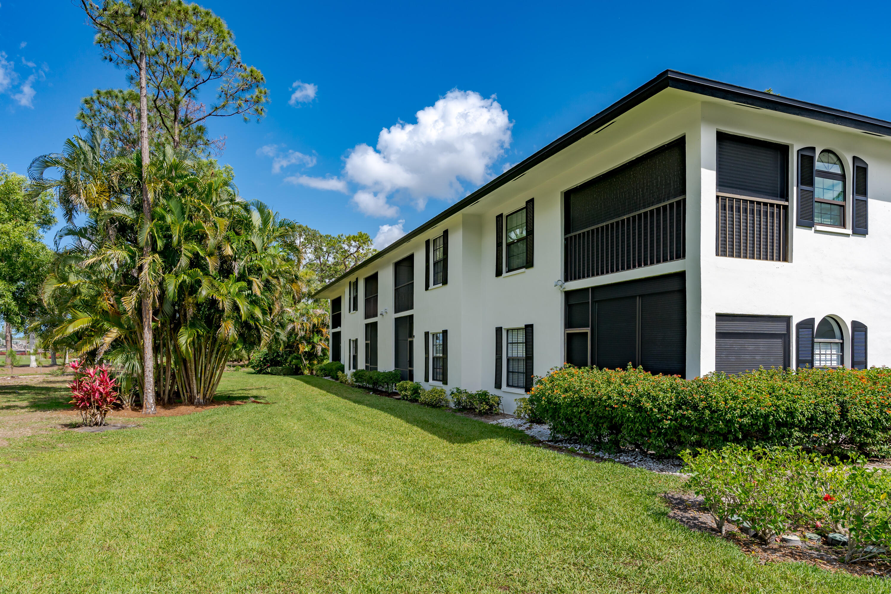 809 Augusta Boulevard, Unit 6 Naples, FL 34113 - Photo 22 of 24 a view of a house with a yard