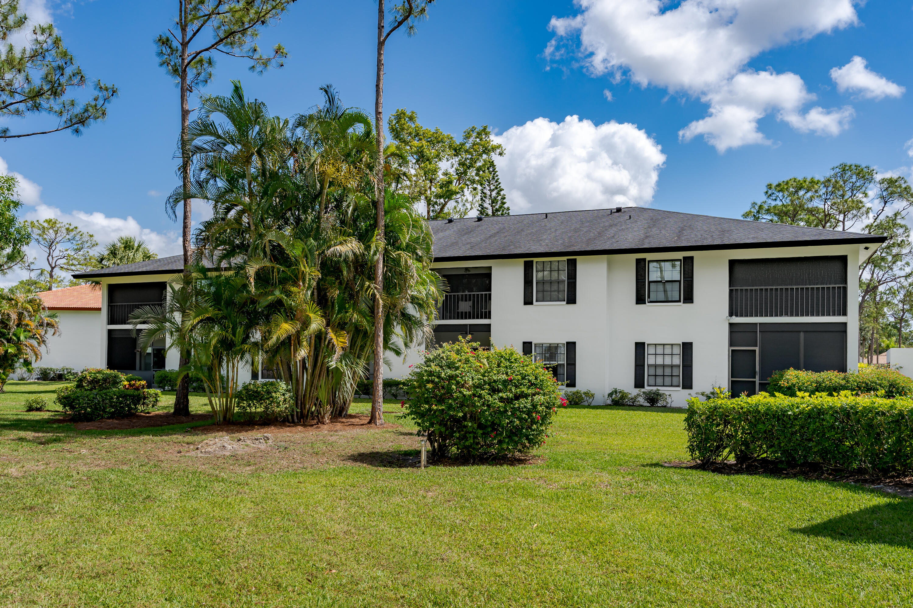 809 Augusta Boulevard, Unit 6 Naples, FL 34113 - Photo 23 of 24 a front view of a house with garden