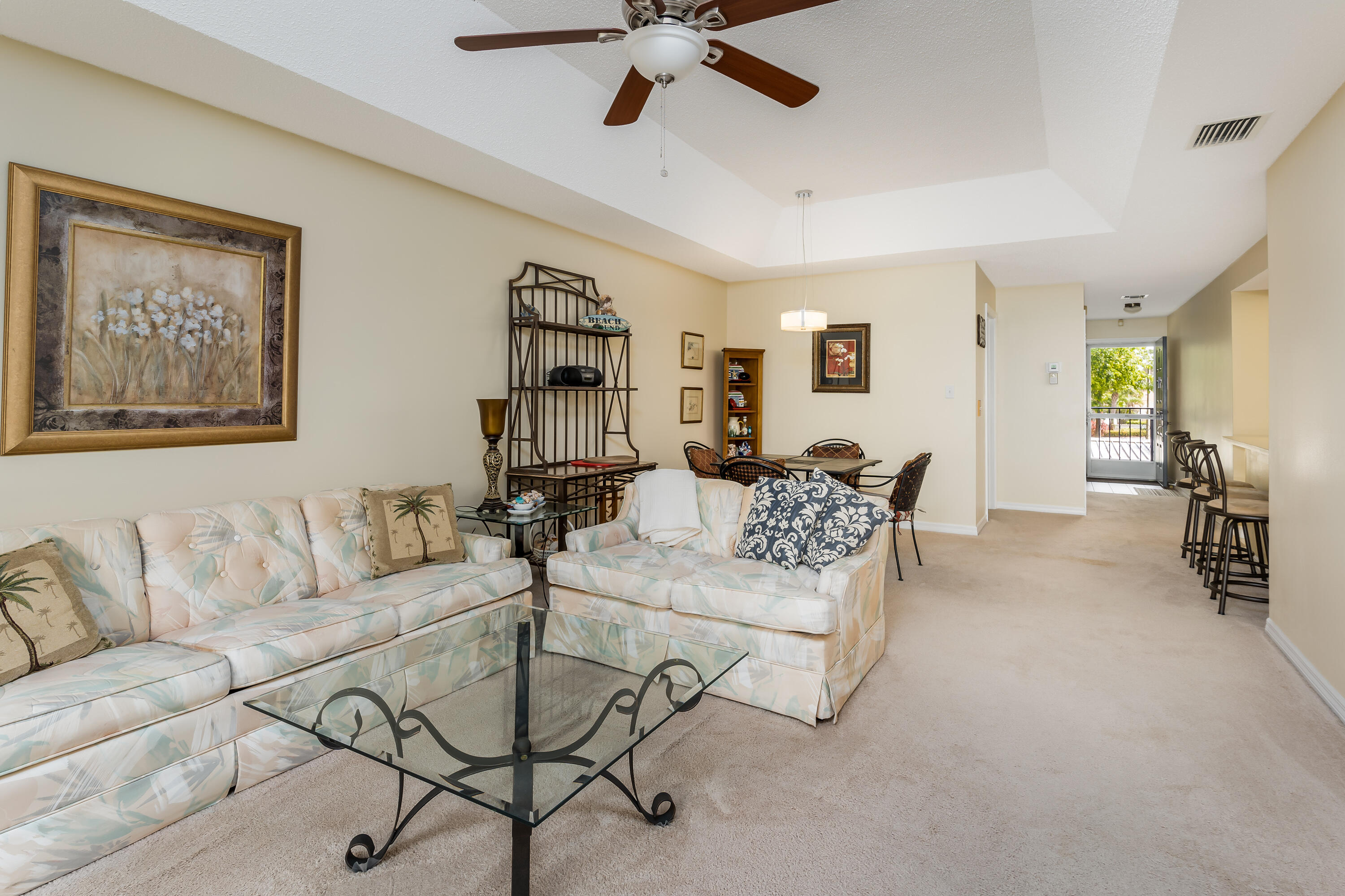 809 Augusta Boulevard, Unit 6 Naples, FL 34113 - Photo 6 of 24 a living room with furniture and a large window