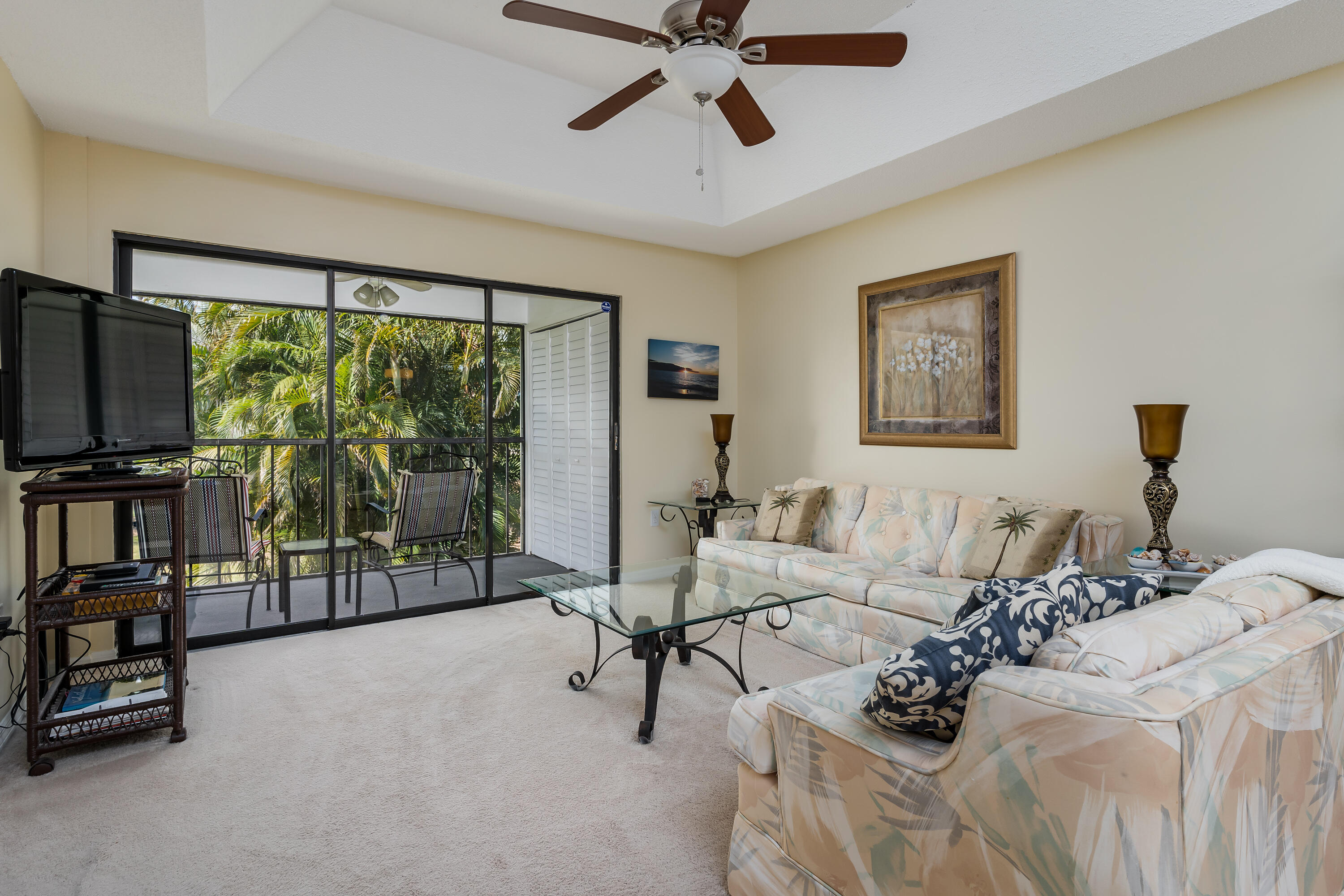 809 Augusta Boulevard, Unit 6 Naples, FL 34113 - Photo 8 of 24 a living room with furniture and a flat screen tv