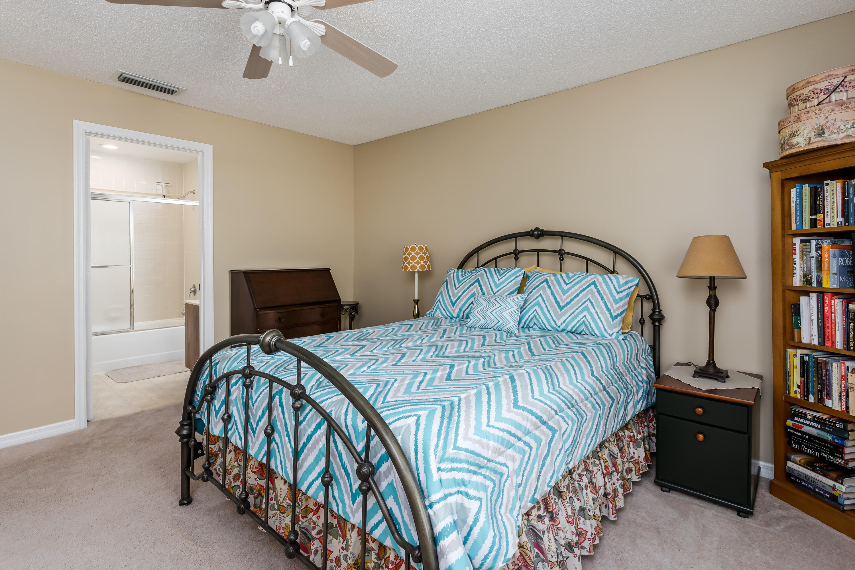 809 Augusta Boulevard, Unit 6 Naples, FL 34113 - Photo 9 of 24 a bedroom with a bed and a book shelf