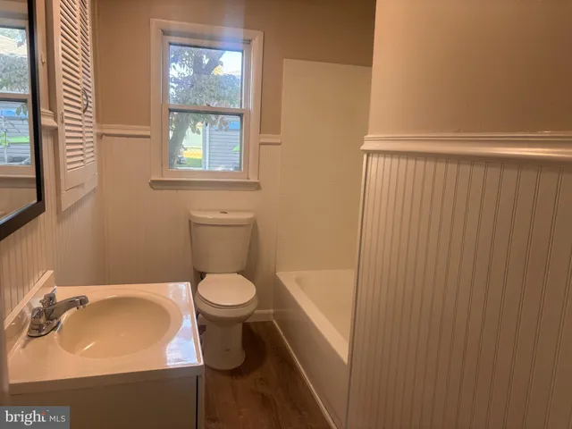a white toilet sitting next to a bathroom sink