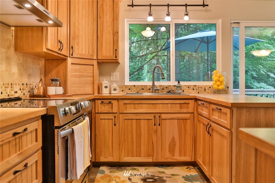 1933 169th Place Southeast Bothell, WA 98012 - Photo 13 of 34 a kitchen with stainless steel appliances granite countertop a sink and a cabinets