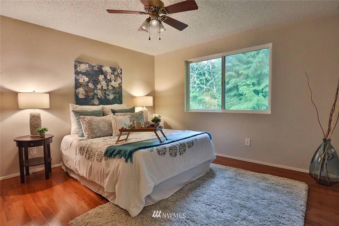 1933 169th Place Southeast Bothell, WA 98012 - Photo 15 of 34 a bed room with a bed and a chandelier