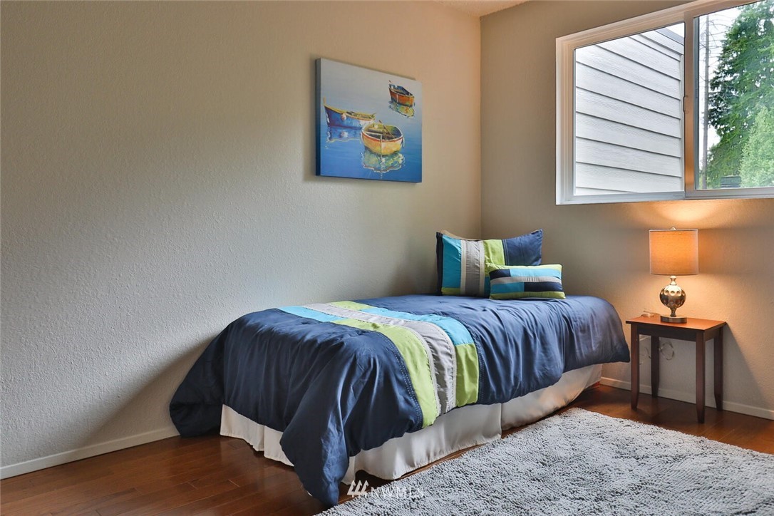 1933 169th Place Southeast Bothell, WA 98012 - Photo 17 of 34 a bedroom with a bed and wooden floor