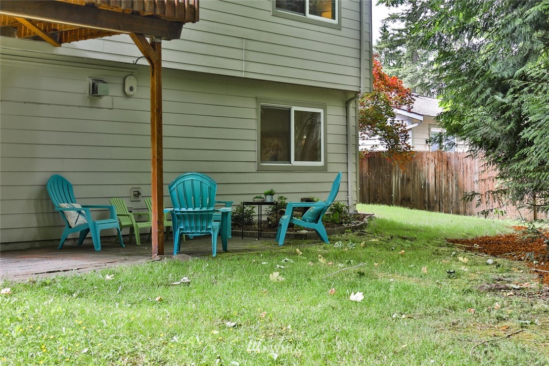 1933 169th Place Southeast Bothell, WA 98012 - Photo 28 of 34 a view of a chair and table in backyard of the house
