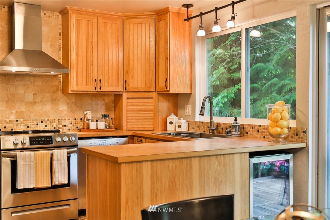 1933 169th Place Southeast Bothell, WA 98012 - Photo 10 of 34 a kitchen with stainless steel appliances granite countertop a sink and a stove