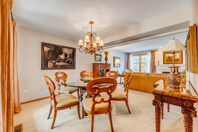 a view of a dining room with furniture and chandelier