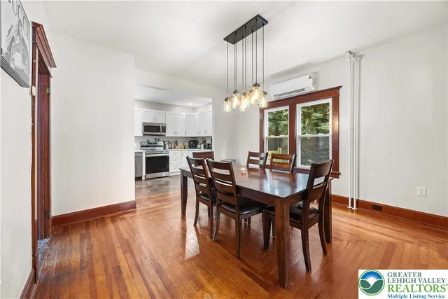 a view of a dining room with furniture and wooden floor
