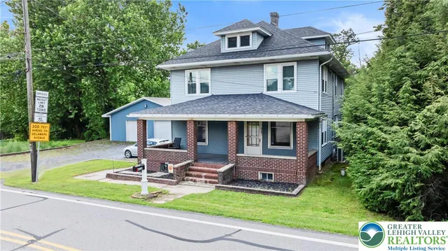 a front view of a house with a yard table and chairs