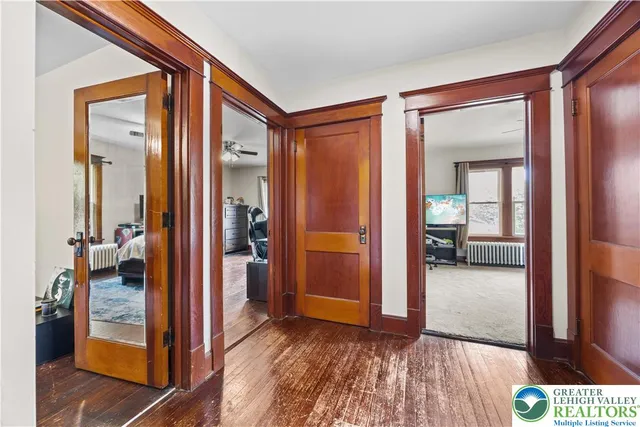 a view of a hallway and a livingroom with furniture