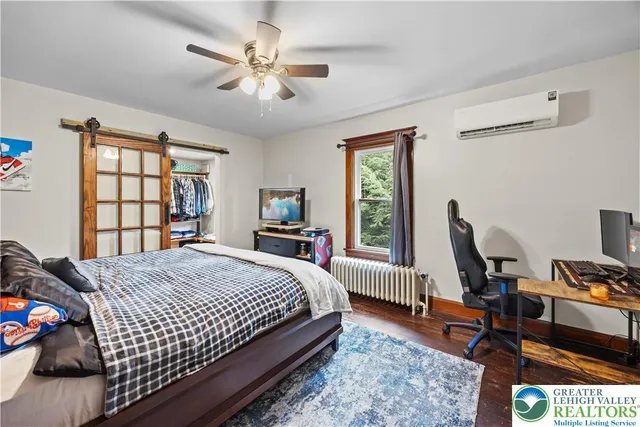 a bedroom with a bed a window and chair