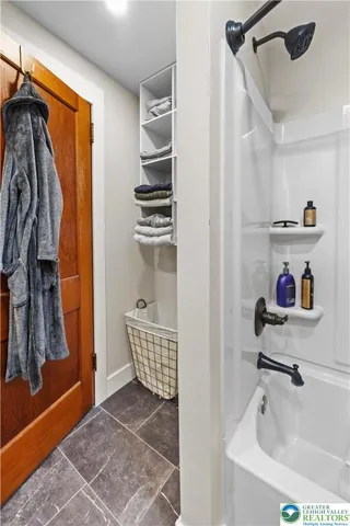 a bathroom with a bathtub and a shower