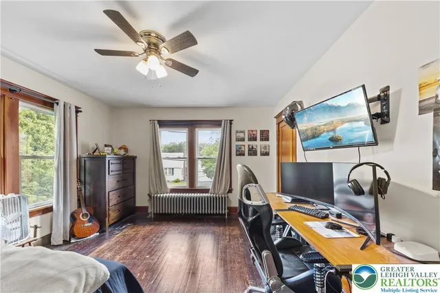 a view of a workspace with furniture and a window