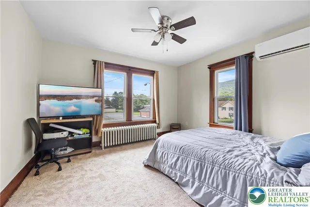 a bedroom with a bed a table and a chandelier