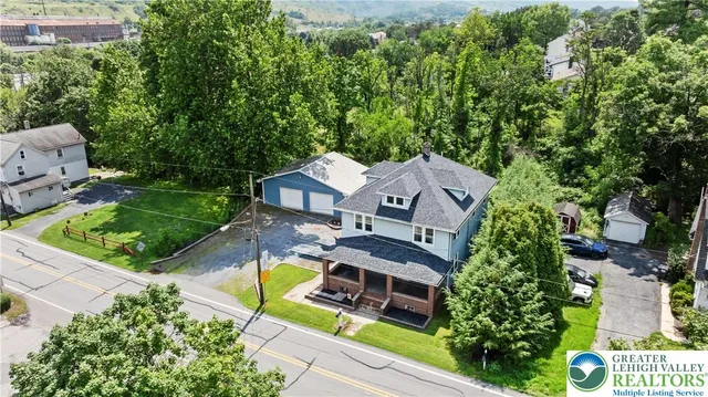 an aerial view of a house with swimming pool and garden view