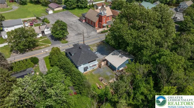an aerial view of a house with outdoor space and street view
