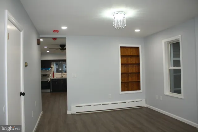 a view of a room with a fireplace and window