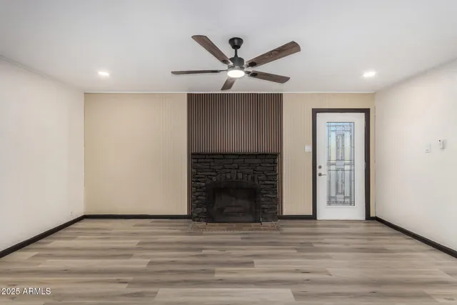 a view of a livingroom with a fireplace and wooden floor