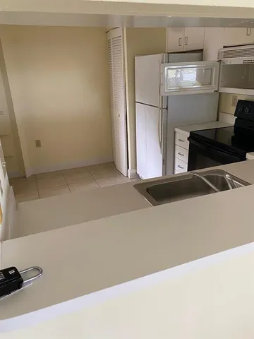 a view of a kitchen with a refrigerator