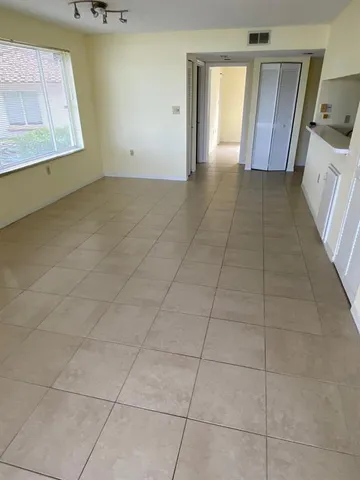 a view of a hallway to rooms and wooden floor