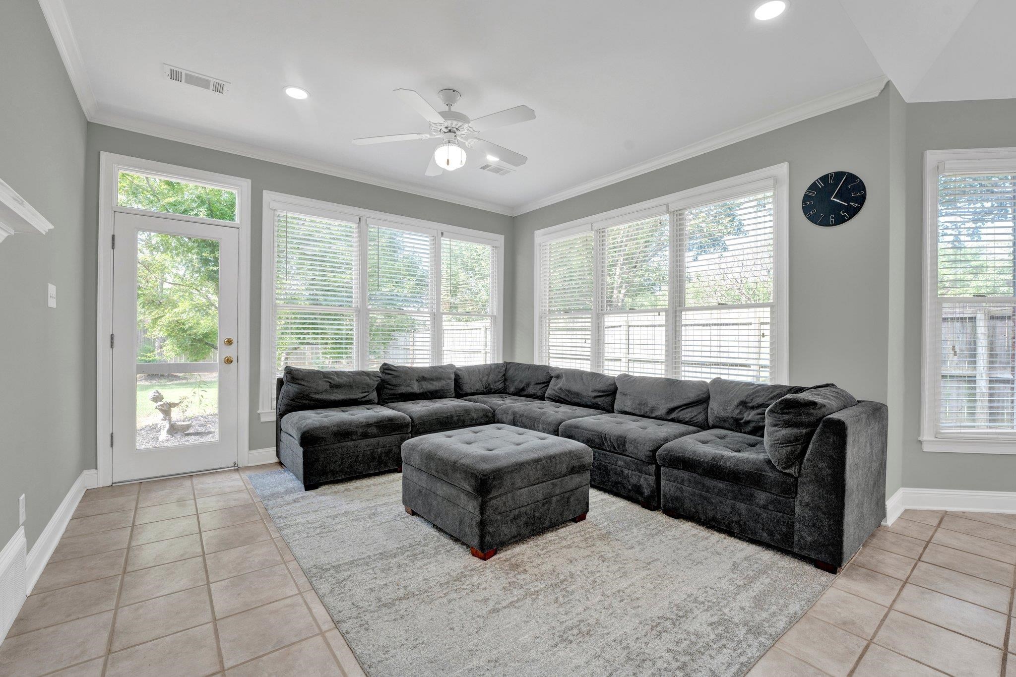 1331 Riding Brook Drive Collierville, TN 38017 - Photo 39 of 39 Living room featuring crown molding, ceiling fan, and light tile patterned floors
