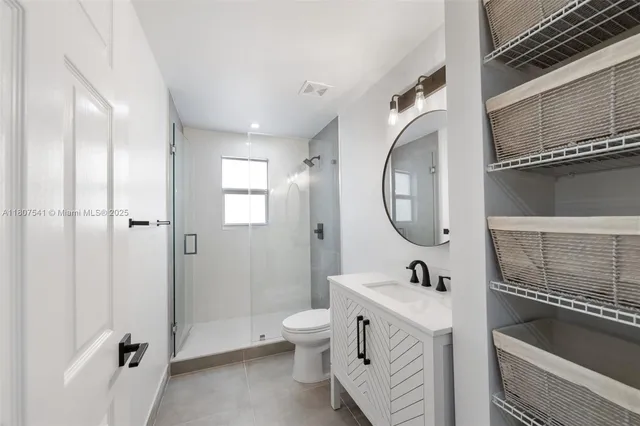 a spacious bathroom with a double vanity sink mirror and toilet